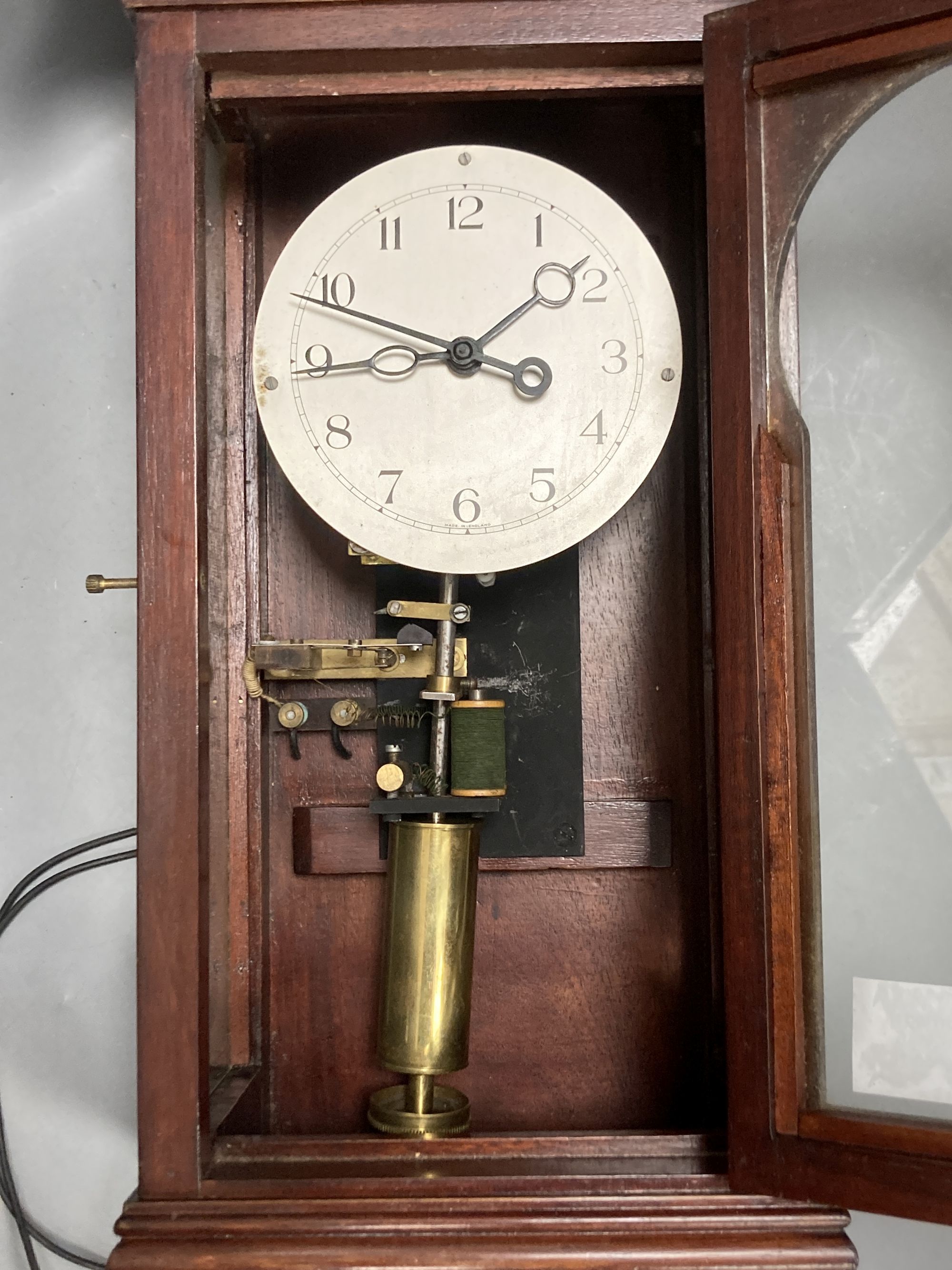 An early 20th century mahogany cased electric wall clock, with acorn pendant, height 66cm